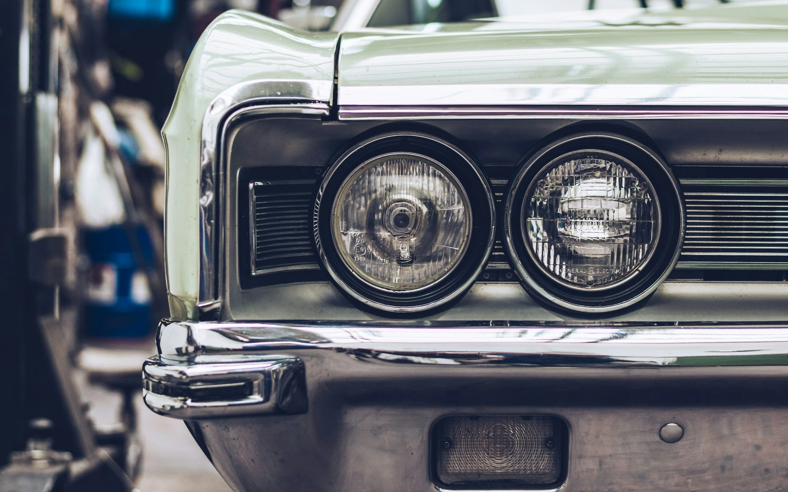 A classic car in a garage workshop