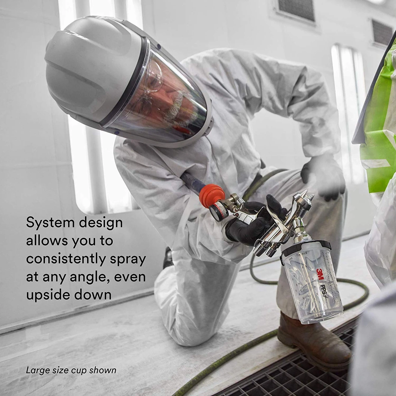 3M PPS Series 2.0 spray cup shown in use on a spray gun at an angled work surface